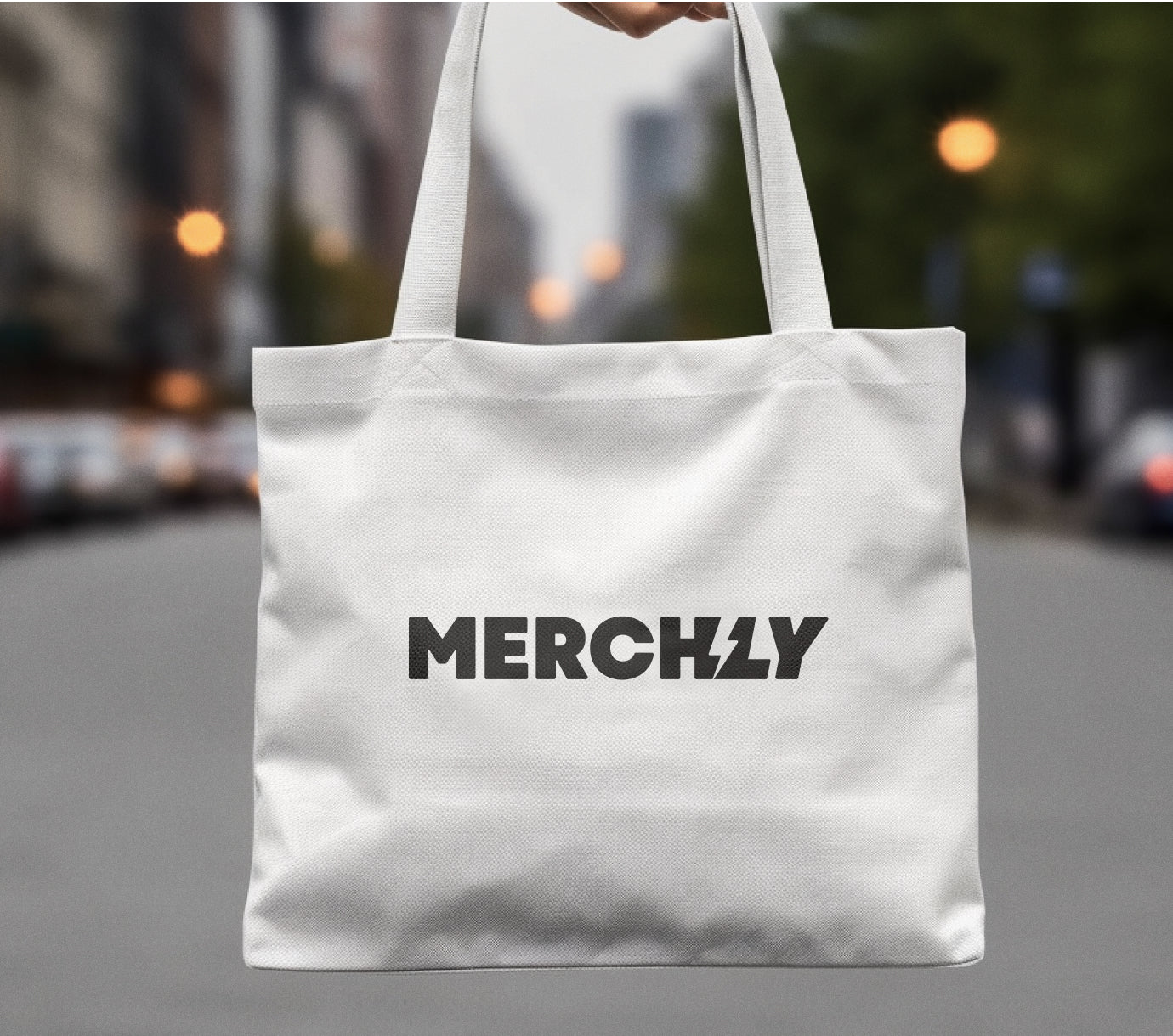 white canvas bag with black Merchly logo across center