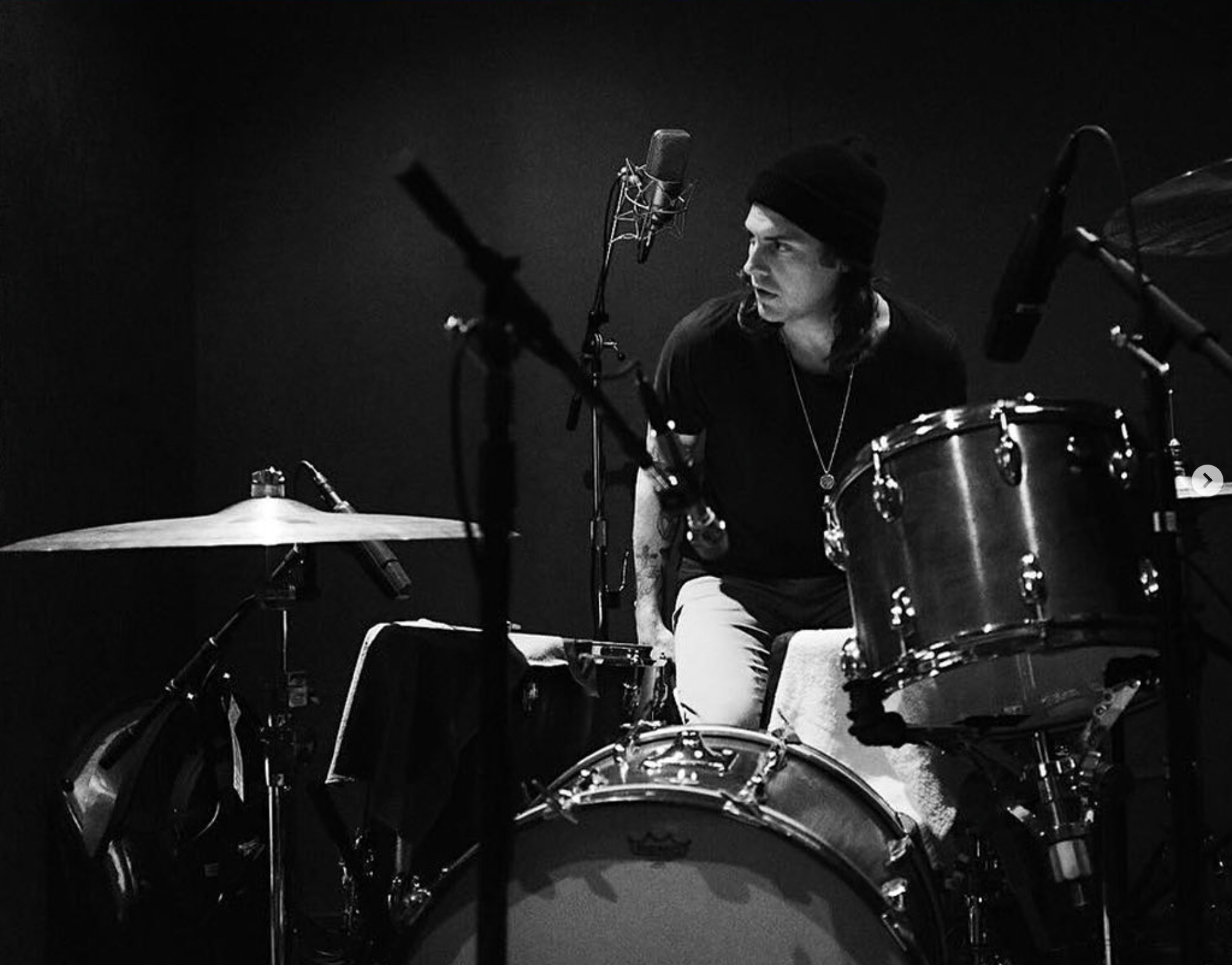 black and white image of Merchly founder Sam Bey playing the drums